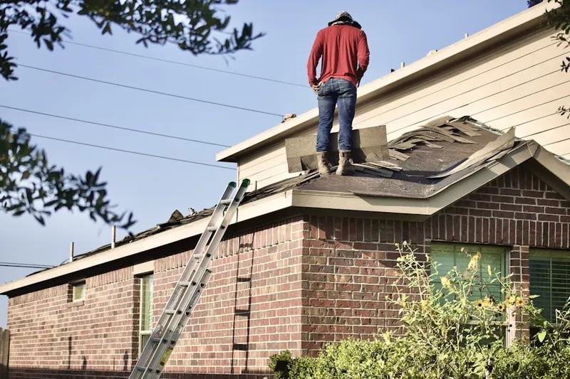 Professional roofer working on a residential roof in Pleasant View